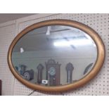 A vintage gilt framed bevelled oval wall mirror with later finish