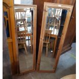 Two modern pine framed narrow oblong wall mirrors