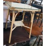 A 21" vintage Lloyd Loom two tier occasional table with brass corners to glass top and original