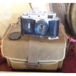 A vintage USSR Zorki-4K rangefinder camera with Jupiter 8 lens, Ever-Ready case, book and tripod, in