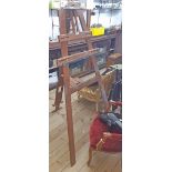 A vintage stained wood artist's studio easel with moulded rails, locking mechanism, and multiple