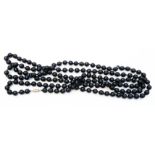 A 20th Century long string of black onyx beads