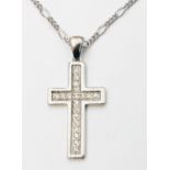 An import marked 375 white gold cross, set with tiny diamonds, on similarly marked chain