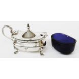 A silver mustard pot with flip top and blue glass liner, initialled "G" - two feet bent