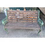 A slatted garden bench with cast iron ends