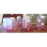 Seven assorted cranberry glass lamp shades including a pair of Edwardian shades