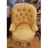 A 19th Century boudoir tub chair with remains of later button back upholstery, set on mahogany