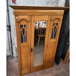 A 3' 3" Edwardian satin walnut single wardrobe with hanging space enclosed by a bevelled mirror