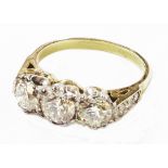 A marked PLAT white and yellow metal three stone diamond ring with further diamonds to shoulders -