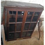 A 3' 3 1/2" antique stained oak book cabinet with pigeon-hole and shelf fitted interior enclosed