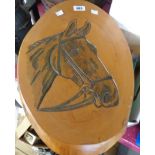 A wood wall plaque with horse head