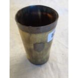 A Victorian horn beaker with silver rim and glass bottom