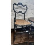 A Victorian ebonised papier-mâché and abalone ornate boudoir chair with trailing foliate gilt
