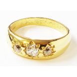A hallmarked 750 gold three stone diamond gypsy set gentleman's ring with heavy shank