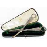 An Elkington, Liverpool cased pair of Elkington & Co. grape scissors with medieval male and female