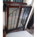A 34 1/2" 1930`s mahogany and mixed wood display cabinet with material lined interior and glass