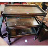A 30" 1920`s stained oak three tier tea trolley with barley twist supports and beaded decoration