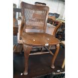 A vintage solid oak framed office elbow chair with damaged bergere back panel and repaired solid