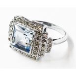 A marked 18ct white metal Art Deco style ring, set with central square aquamarine within a diamond