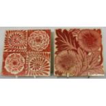 Two William de Morgan ruby lustre tiles depicting hand painted floral designs