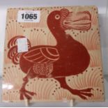 A William de Morgan ruby lustre tile depicting the Dodo - rubbed and chipped to edge