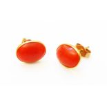 A pair of marked 750 yellow metal oval coral panel ear-rings