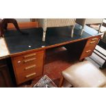 A 5' 6" vintage Blue Line sapele wood veneered kneehole office desk with leatherette part inset top,