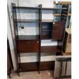 A 4' 1" vintage Staples Ladderax stained mixed wood wall unit with six shelves, three uprights, twin