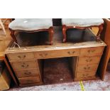 A 4' 8" late 19th Century waxed pine twin pedestal desk with worn tooled leather inset top, three