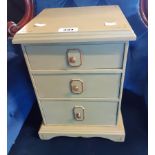 A 10 1/4" painted mahogany miniature chest of three long graduated drawers with moulded top and