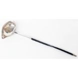 A George II brandy ladle with whale bone handle and 1762 Threepence set bowl