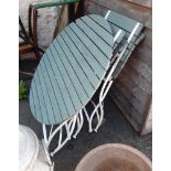 A wrought iron and wooden folding garden table and two chairs