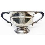 An 8 1/2" diameter silver pedestal trophy cup with wide flanking scroll handles - Devonshire RGA