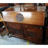 A 4' 19th Century walnut bureau base with carved roundel decoration and fitted interior over two