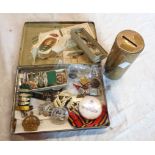 An old Players cigarette tin containing various enamelled badges including For Home and Country,