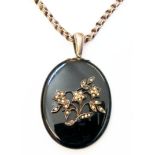 A 5cm oval black onyx and seed pearl mourning pendant, on marked "Sterling" chain - back glass