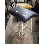 A vintage painted metal framed stool with fold-out foot rests - replacement upholstery seat