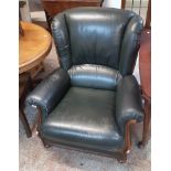 A modern Italian green leather upholstered armchair with polished wood part show frame to front, set