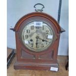 An early 20th Century mahogany and stained wood cased dome top bracket clock with Arabic numerals to