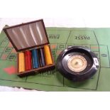 A vintage roulette game including wheel, mat, and boxed set of chips