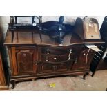 A 5' early 20th Century walnut break bow front sideboard with two central drawers and double