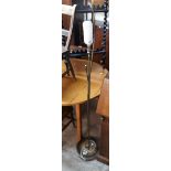 A retro brassed metal and polished wood standard lamp with stitched velum style disc shade and