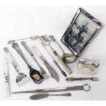 A bag containing ornate silver plated cutlery items, silver butter knife, coin spoon and "