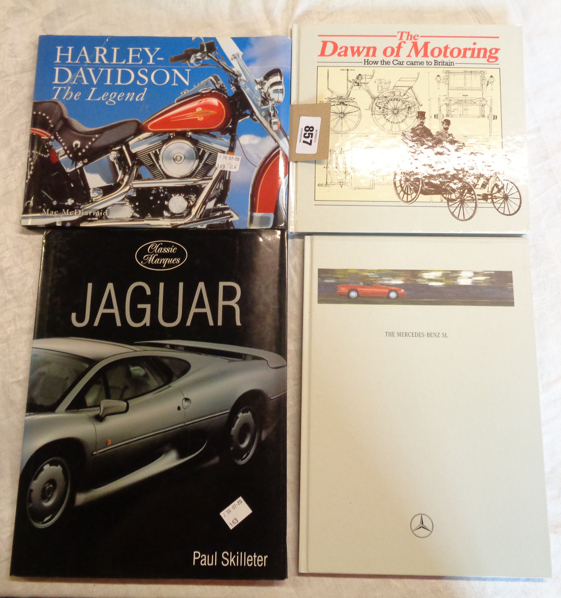 A small collection of automobila related books and ephemera including Harley Davidson, Jaguar, etc.