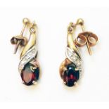 A pair of import marked 375 gold drop ear-rings, each set with oval garnet and tiny diamonds -