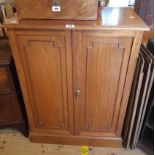 A 27" early 20th Century mahogany cabinet with three shelves enclosed by a pair of beaded panelled