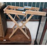 A pair of 20th Century blond wood folding luggage stands - for re-polishing