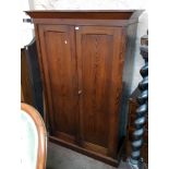 A 4' 4" early Victorian pitch pine double wardrobe with hanging space and long deep drawer