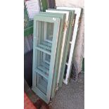 Three pairs of green painted casement windows