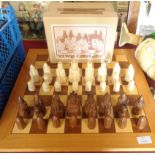 A vintage boxed set of Lewis chessmen by Petrushkin games and associated board